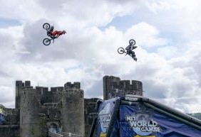 caerphilly-wales-uk-10th-september-2019-three-freestyle-motor-cross-fmx-stars-perform-the-never-seen-before-synchronised-double-backflip-train-in-front-of-equally-spectacular-caerphilly-castle-stunt-performers-jack.jpg