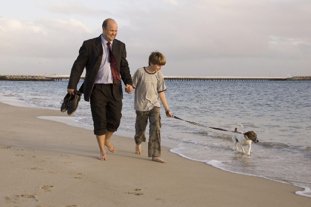 Suited-man-and-kid-walk-on-beach-with-dog.jpg